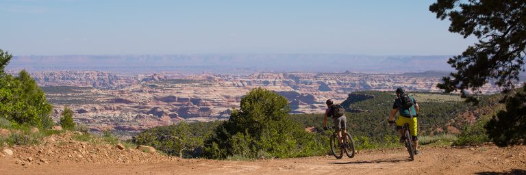 A rider on Bears Ears tour follows a guide down past Boundary Butte on Day 3