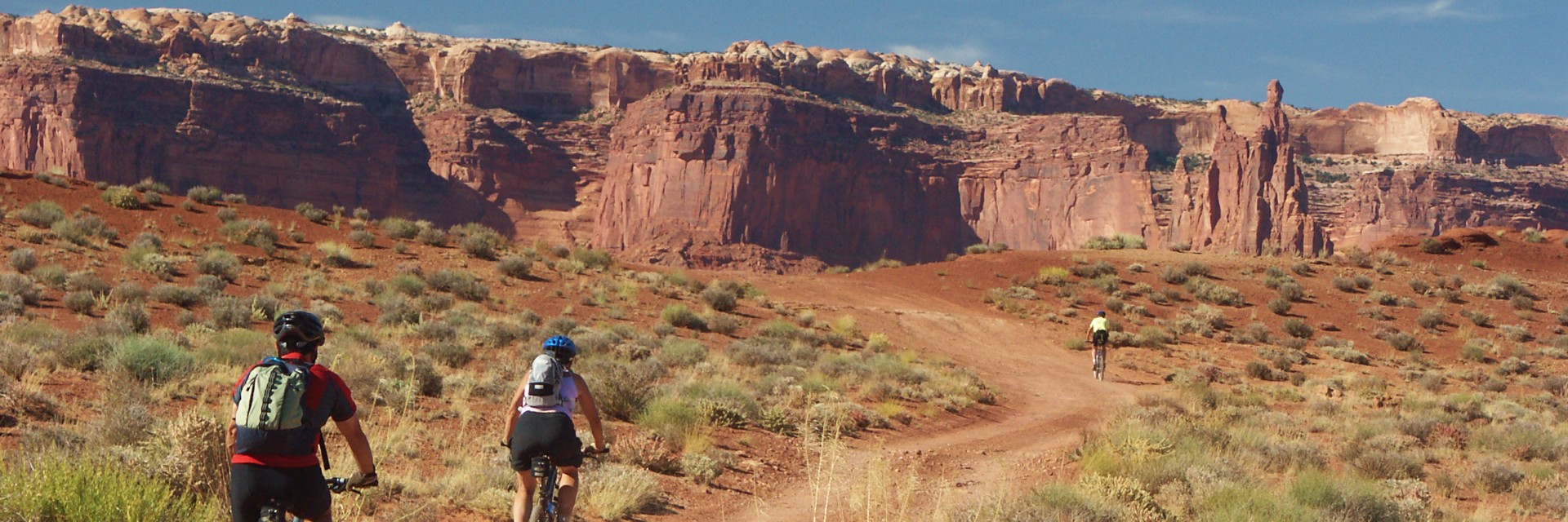 Mountain bikers on the White Rim Trail with canyon views